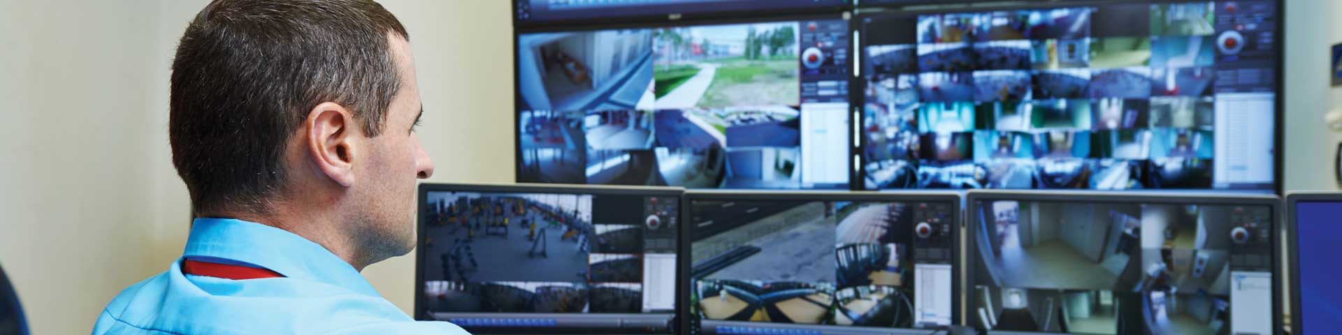Security officer monitoring surveillance screens.