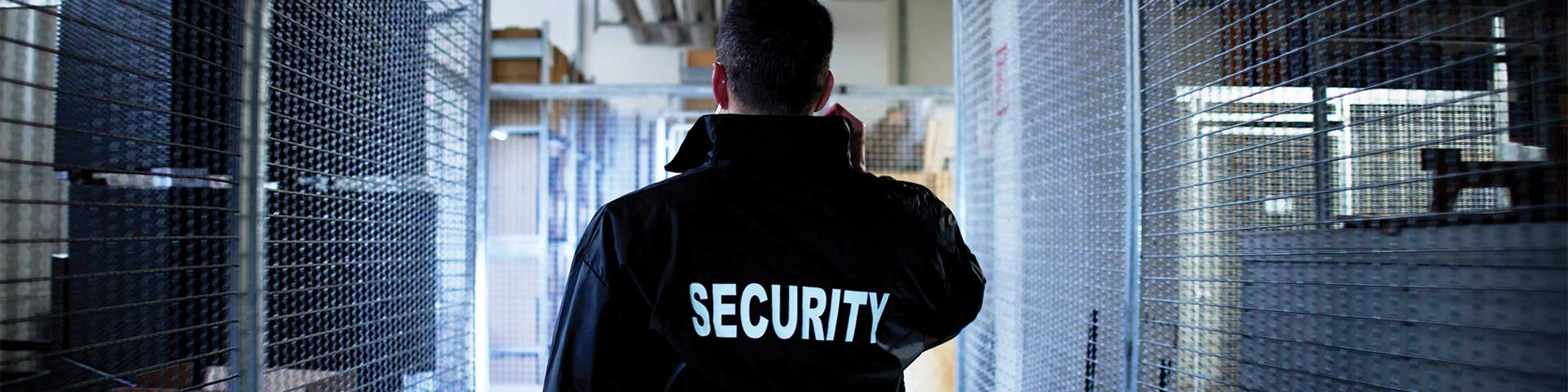 Security guard walking in a warehouse.